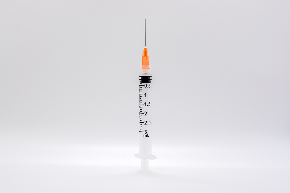 A single syringe on white background